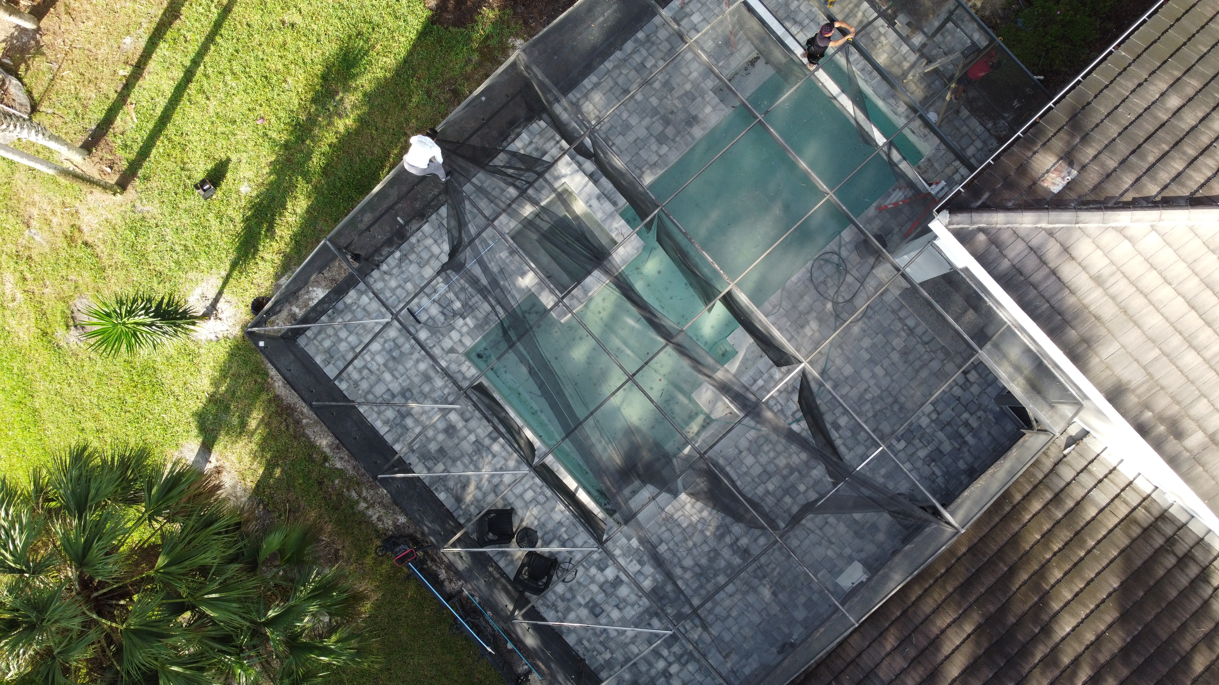 Workers rescreening pool cage